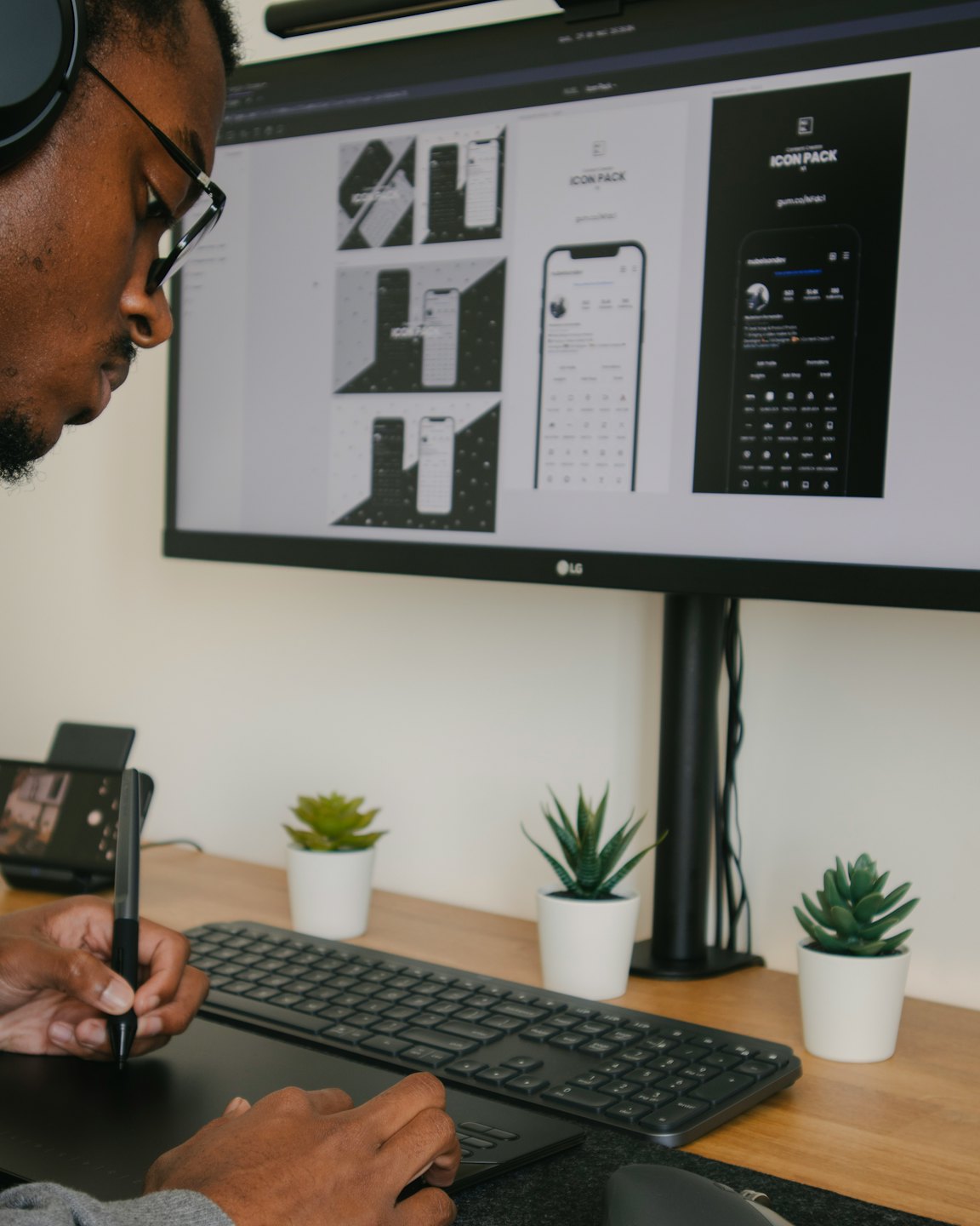 Designer working on a mobile app mockup on a computer.